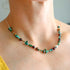 Turquoise beaded necklace with cherry amber and sterling silver on a woman&