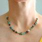 Handcrafted turquoise beaded necklace with cherry Baltic amber and 925 sterling silver on neck