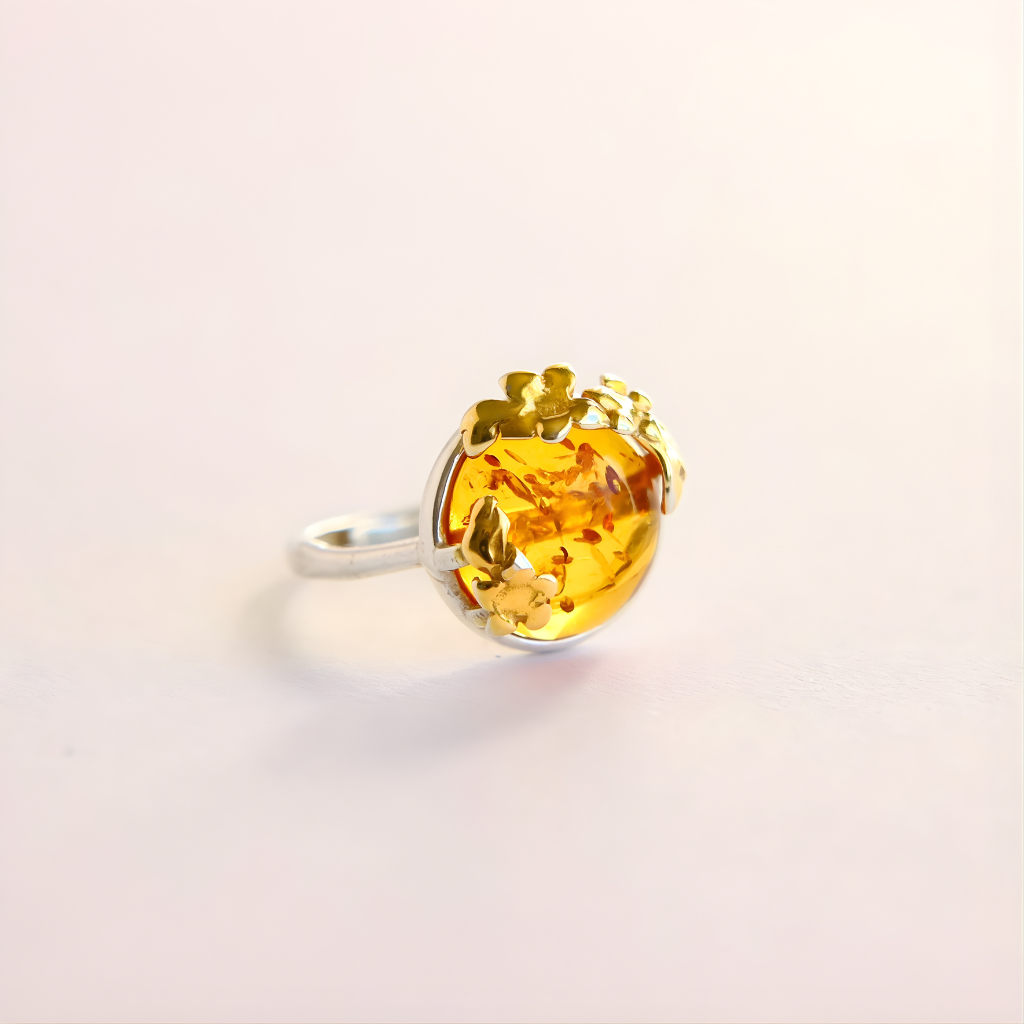 flower Ring with a yellow gemstone on a light pink background