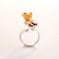 Gold and silver amber ring with honey bee design on a light gray background