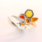 amber Ring with geometric design and colored stones on a white background