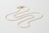 dainty cable chain necklace on neutral white background