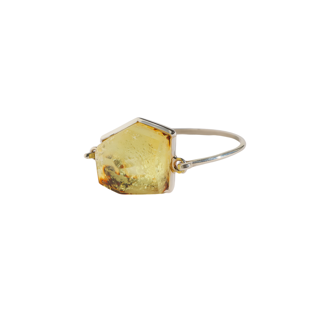 Green amber bracelet with sterling silver band and modern cut design.