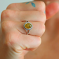 green oval cut ring top view on hand