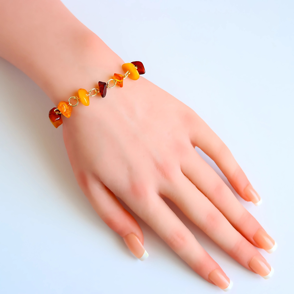 Handmade Baltic amber bracelet with butterscotch, cherry, and cognac stones on gold-colored chain.