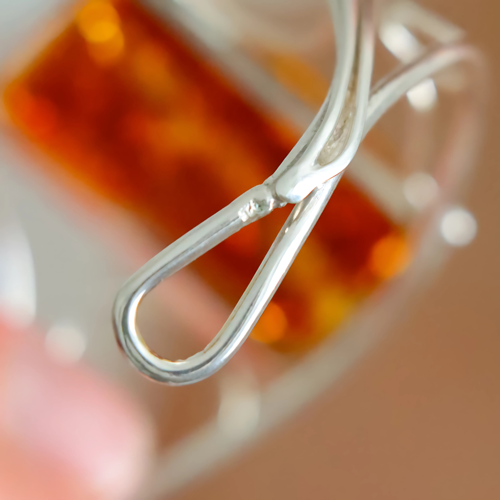 Close-up of a silver cuff bracelet against a blurred background