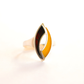 Gold and black amber ring with a unique design on a white background