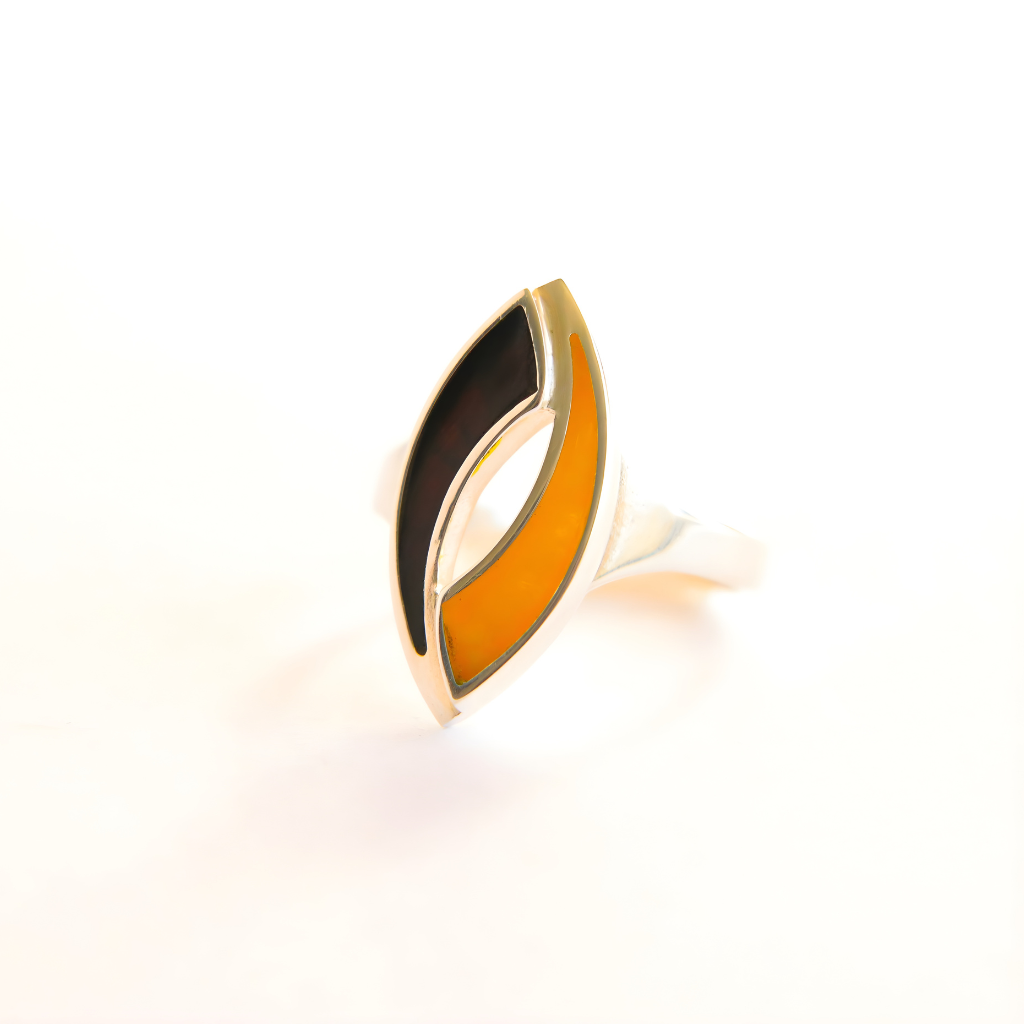 Amber ring with black and orange design on a white background
