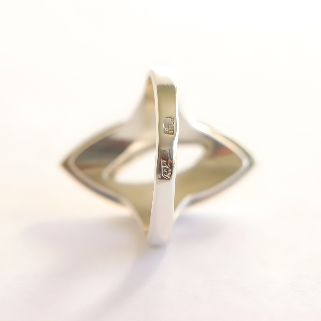 silver amber ring with a subtle design on a white background