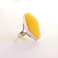 butterscotch amber Ring with a yellow teardrop-shaped stone on a white background