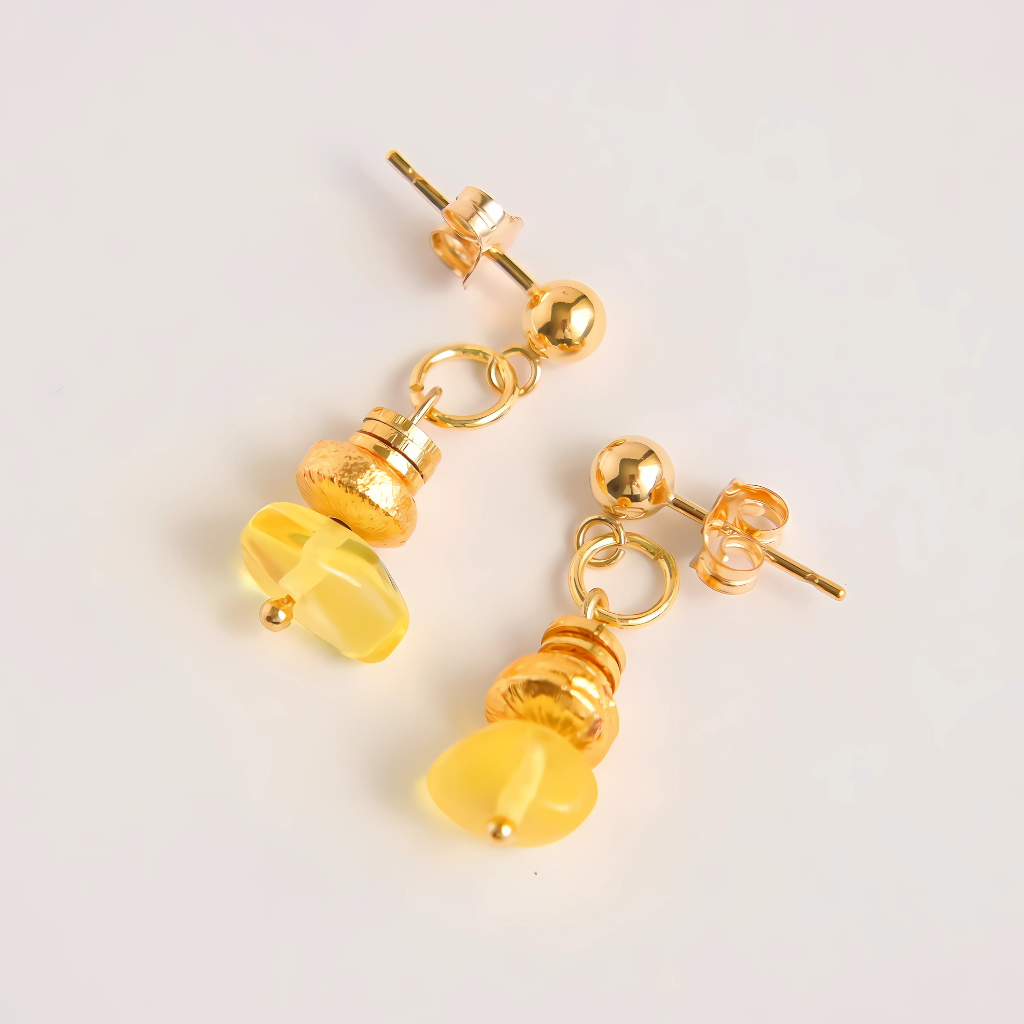 Baltic lemon amber earrings in gold by artist Alexis Cintron, featuring unique handmade design with sparkling gemstones.