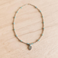 Turquoise Necklace on white wood background with silver pendant