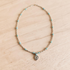 Turquoise Necklace on white wood background with silver pendant