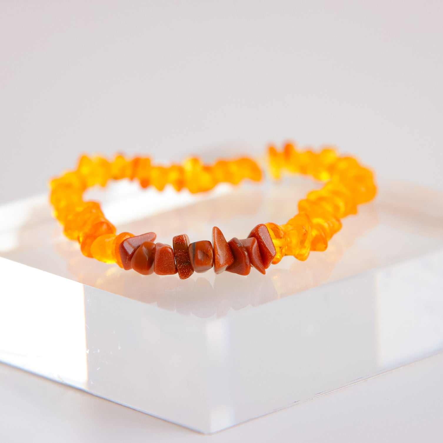 baltic amber bracelet Baltic Honey Amber and Gold Gemstone Bracelet on display, featuring unique handcrafted amber chips with warm honey tones.