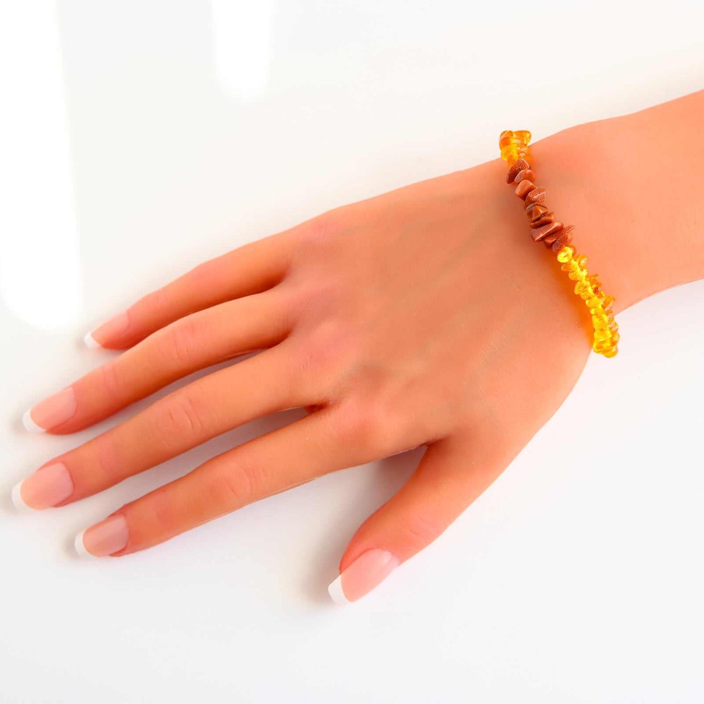 Baltic Honey Amber and gold gemstone bracelet on wrist, showcasing unique and stylish handcrafted design with natural tones.- baltic amber bracelet