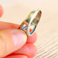 Close-up of adjustable sterling silver frog ring showing open band construction and polished silver interior.