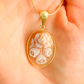 Gold flower necklace pendant held in a hand