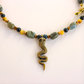 Beaded Necklace with snake pendant  on a white background
