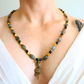 beaded Necklace with a snake pendant worn by a person on a white background