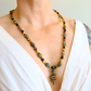 beaded Necklace with a snake pendant worn by a person in a white top