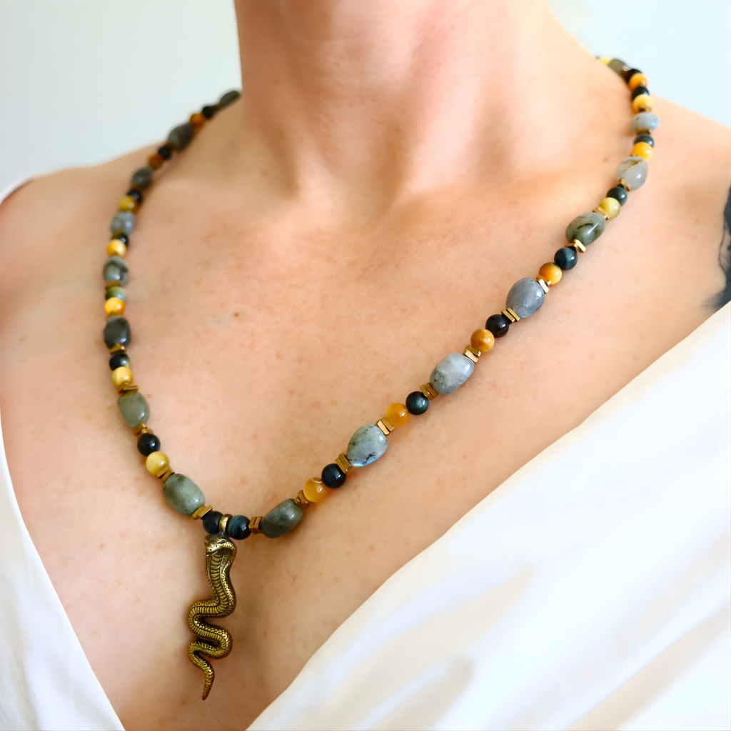 beaded Necklace with snake pendant worn by a person on a plain background