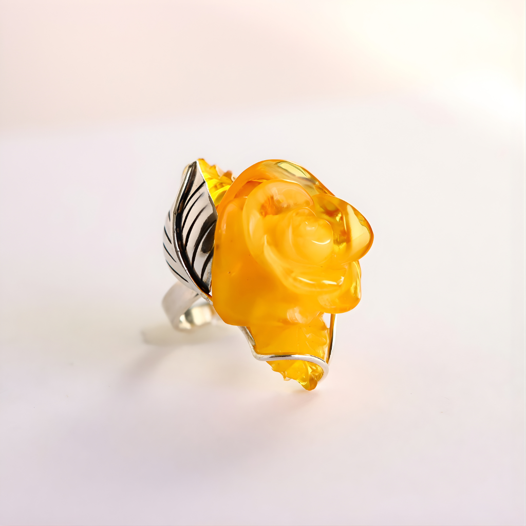Rose Ring with a yellow rose-shaped gemstone on a light background