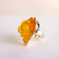 Rose Ring with a yellow gemstone on a white background