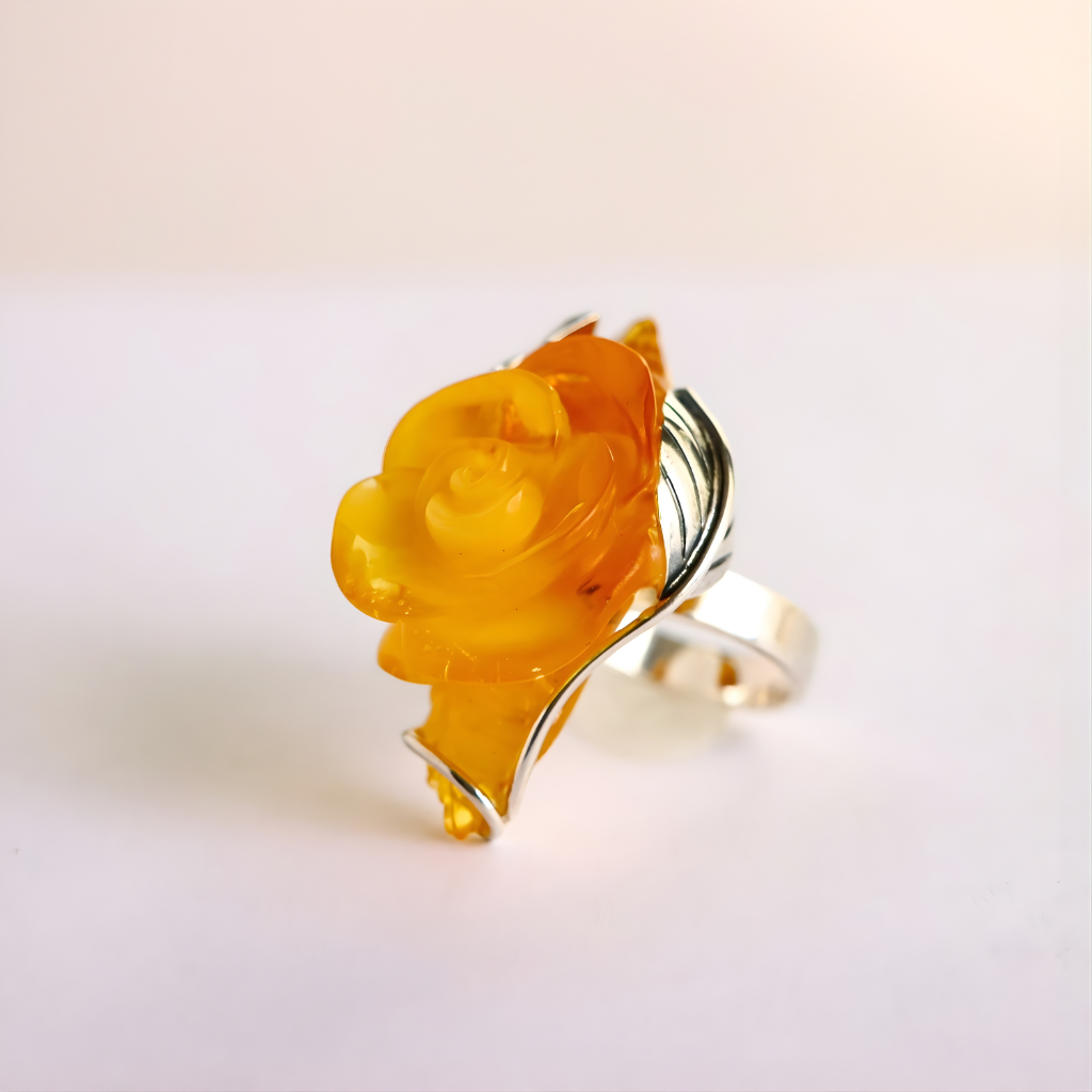 Rose Ring with a yellow gemstone on a white background