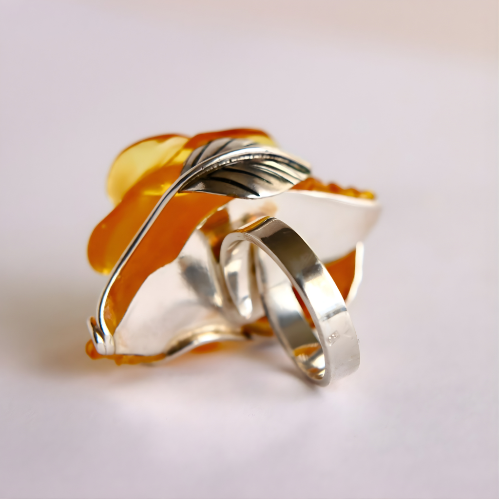 yellow and silver rose ring on a light gray background