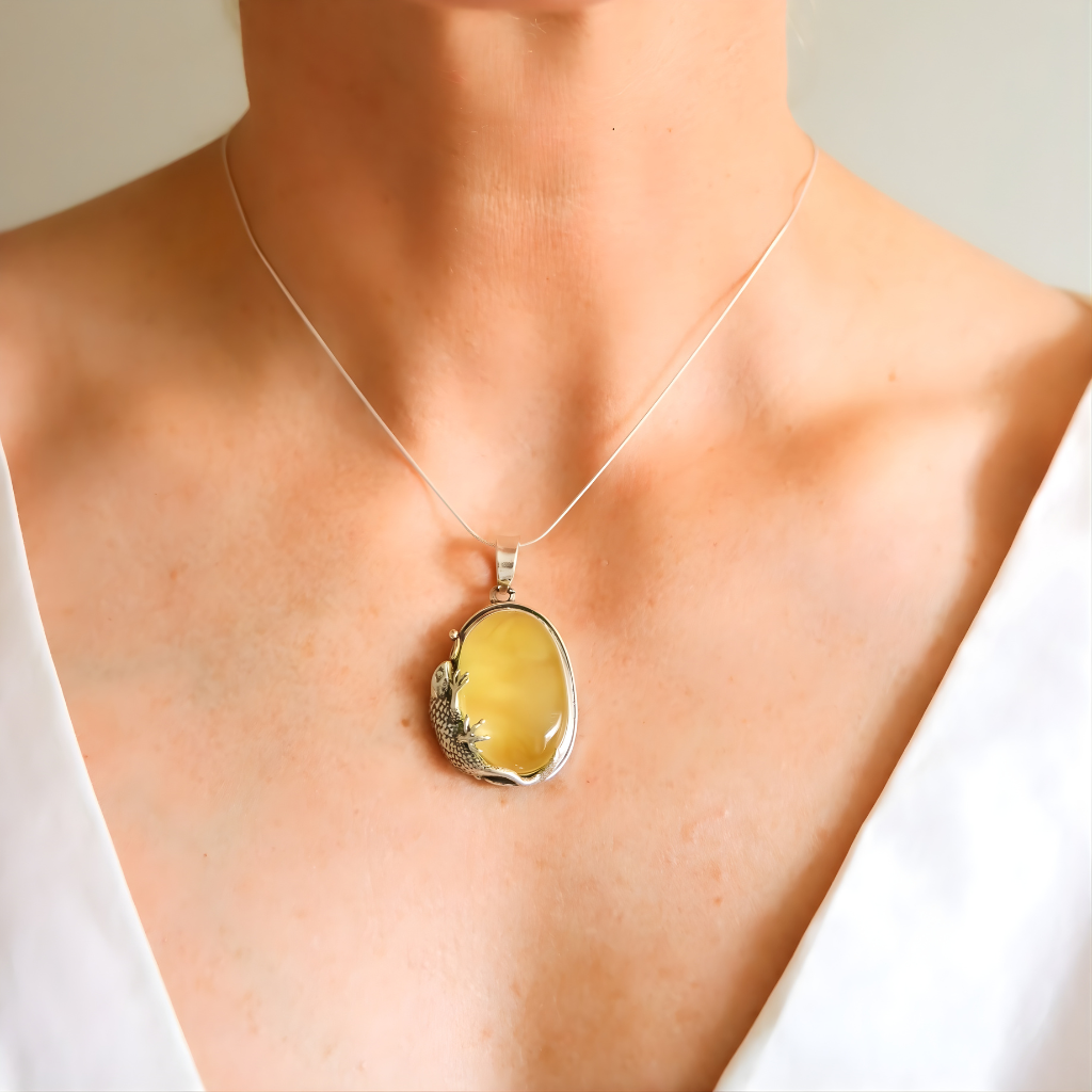 Yellow pendant amber necklace on a mannequin with a plain background