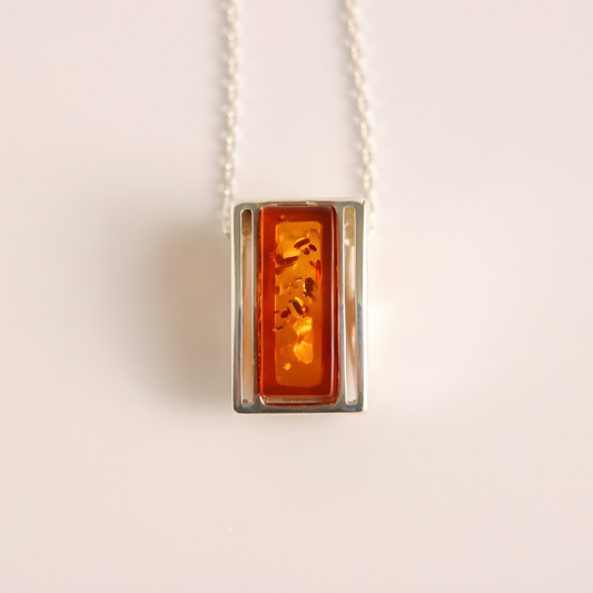 amber Necklace with a rectangular amber pendant on a light background