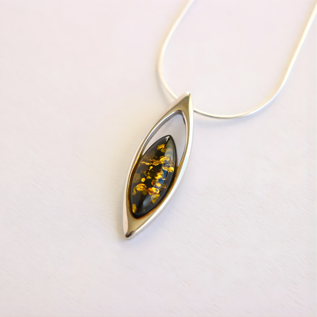 amber necklace. Teardrop-shaped pendant with embedded stones on a white background