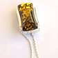 green Amber pendant necklace on a white background