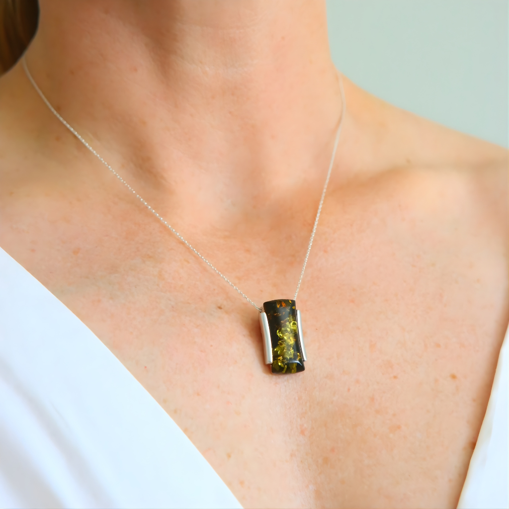 green amber Necklace with a pendant worn by a person on a plain background