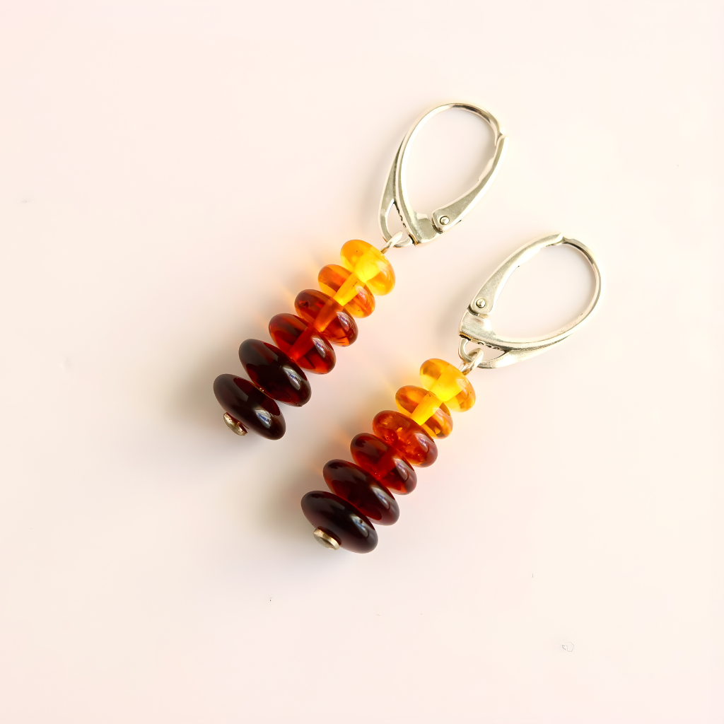 Pair of beaded  amber earrings on a light beige background
