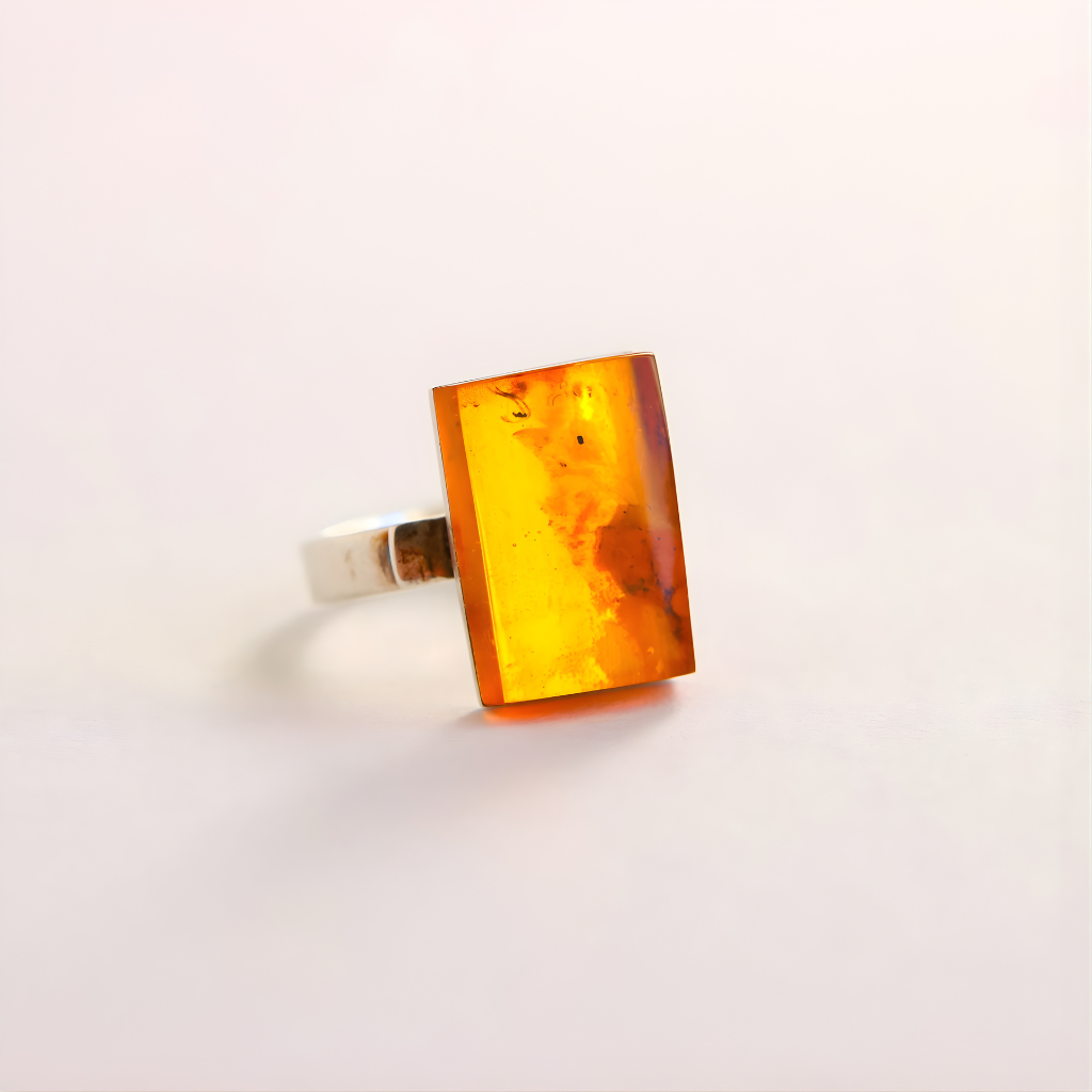 Amber Ring with a rectangular amber stone on a light gray background