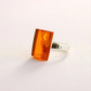 amber Ring with amber stone on a light background
