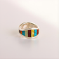 Silver amber ring with colorful inlay on a light gray background