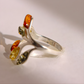 Silver amber ring with amber stones on a light background