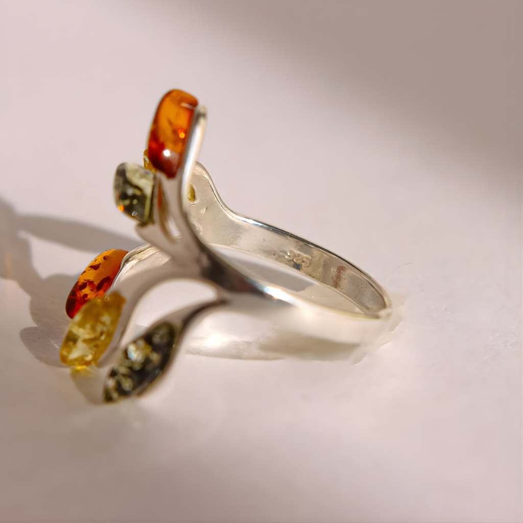 Silver amber ring with amber stones on a light background