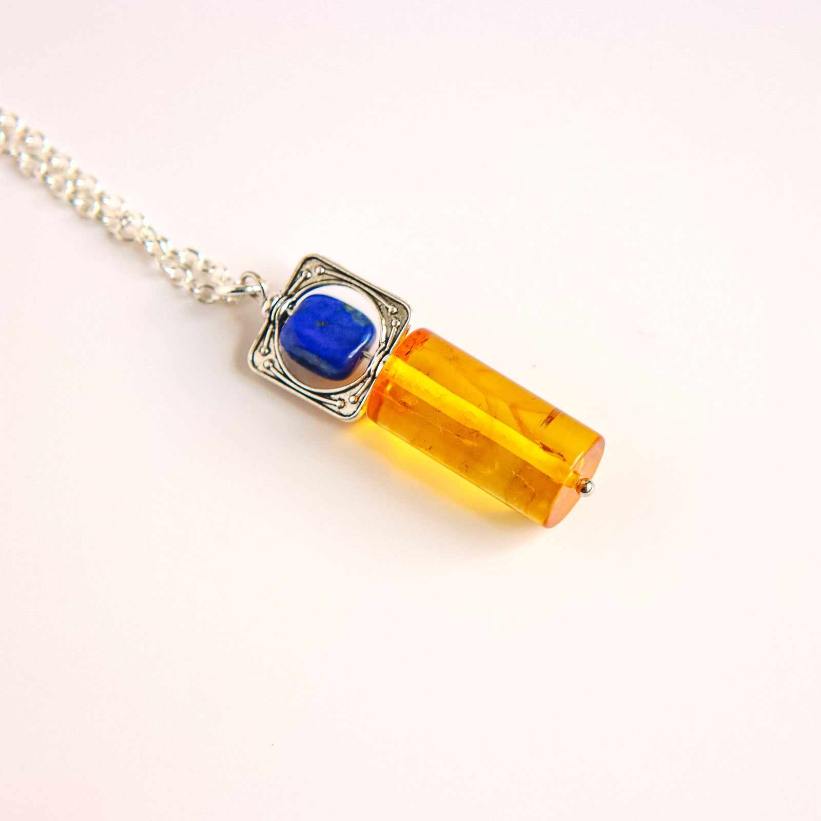 Silver-plated lobster claw clasp and 16-inch chain detail from handmade lapis lazuli and amber necklace.