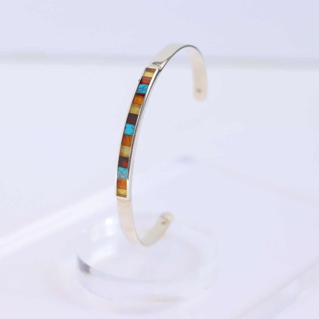 Handmade cuff bracelet with natural Baltic amber and turquoise mosaic design, crafted in 925 sterling silver.