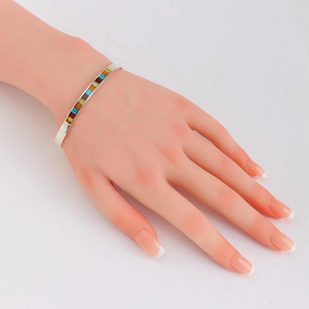 Natural Baltic Amber and Turquoise Cuff Bracelet on wrist, handmade with sterling silver, modern-chic design.