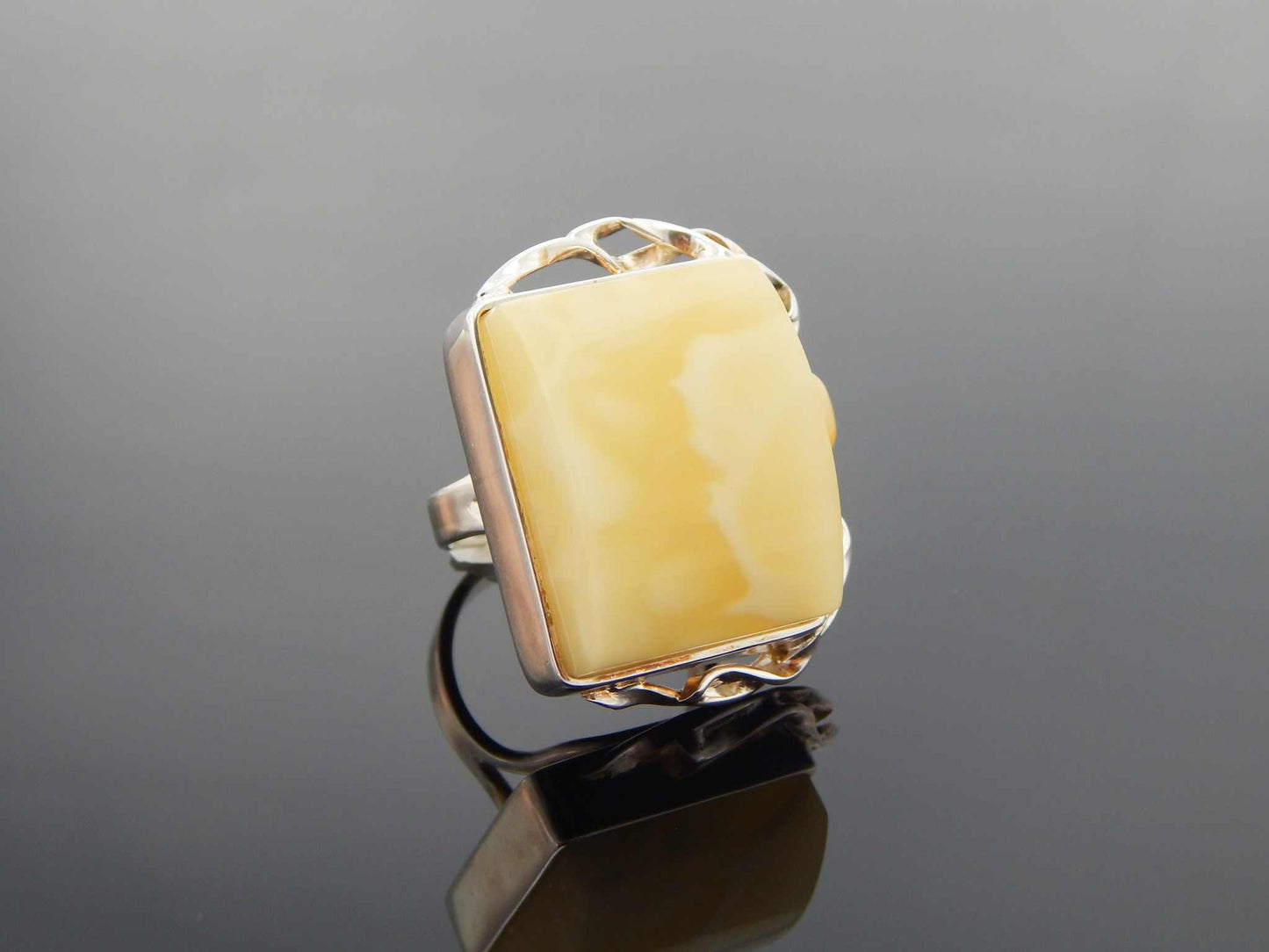Natural Baltic butterscotch amber ring in 925 sterling silver with avant garde design.