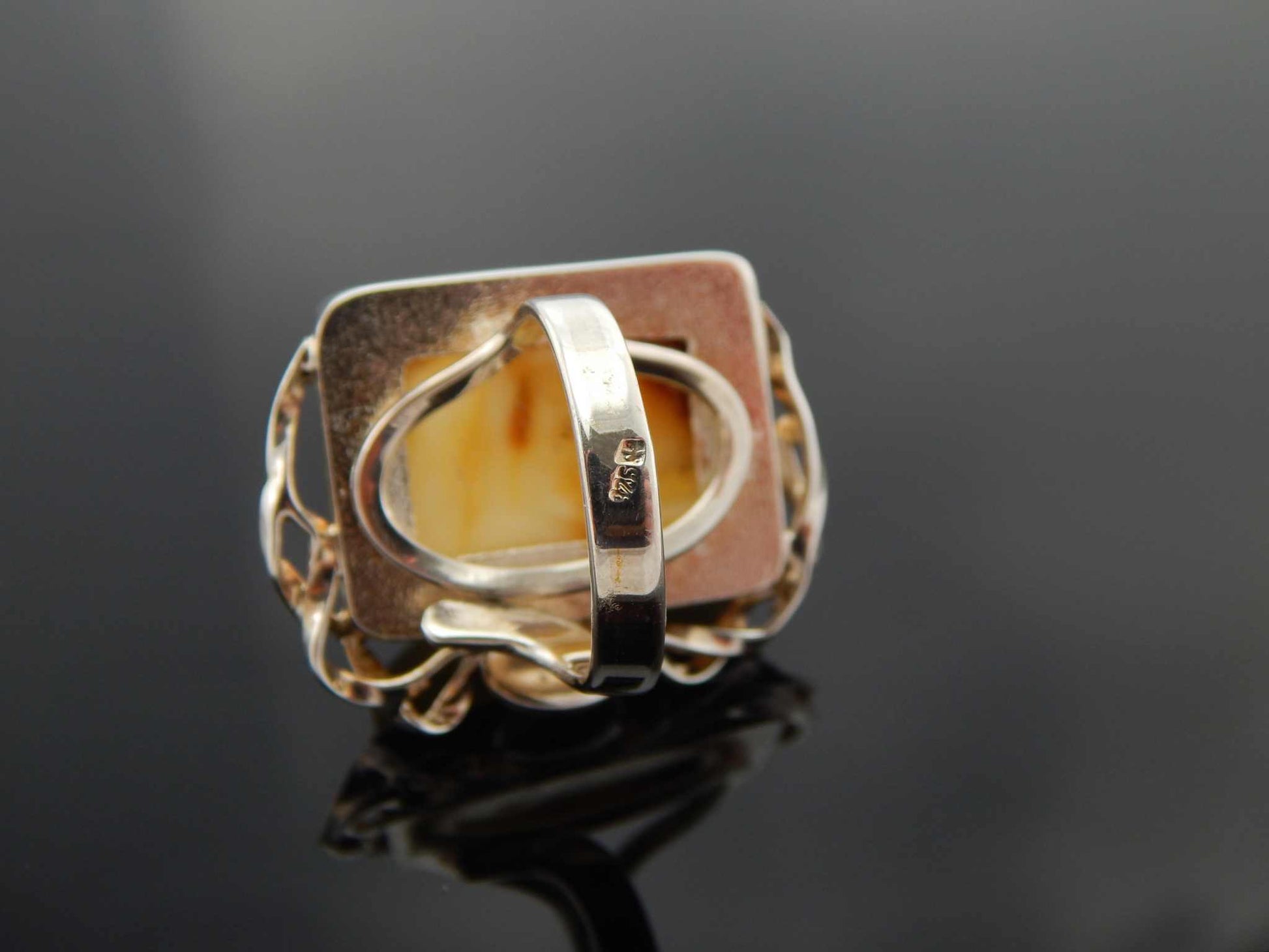 Natural Baltic butterscotch amber avant garde ring with twisted sterling silver band.