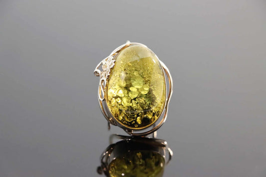 Natural Baltic green amber floral ring in 925 sterling silver with adjustable band.