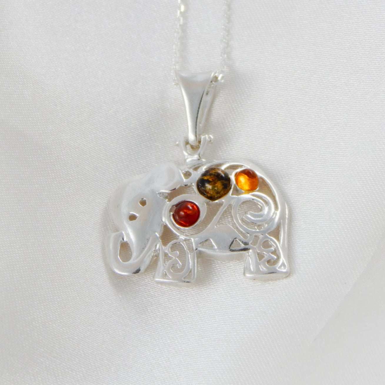 Natural Baltic multicolor amber lucky elephant pendant necklace with 925 sterling silver, 18-inch chain.