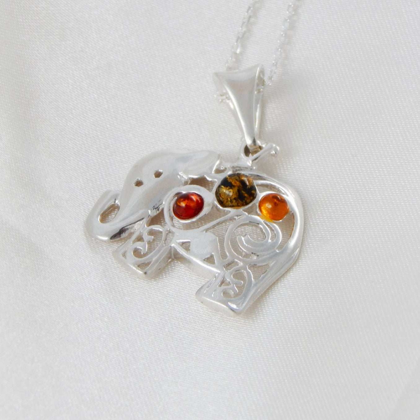 Natural Baltic multicolor amber elephant pendant necklace with sterling silver chain.