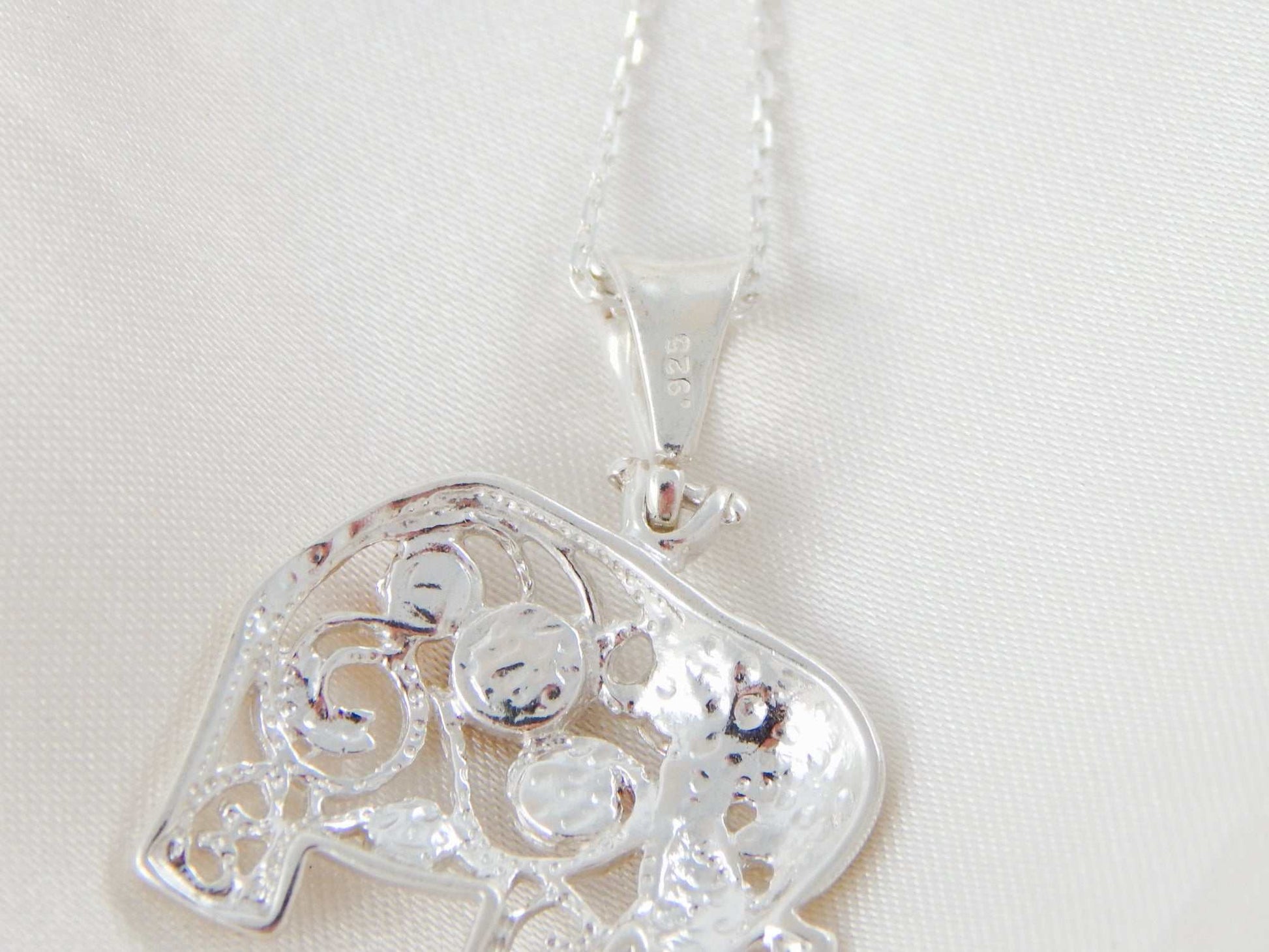 Natural Baltic multicolor amber elephant pendant necklace with sterling silver chain.