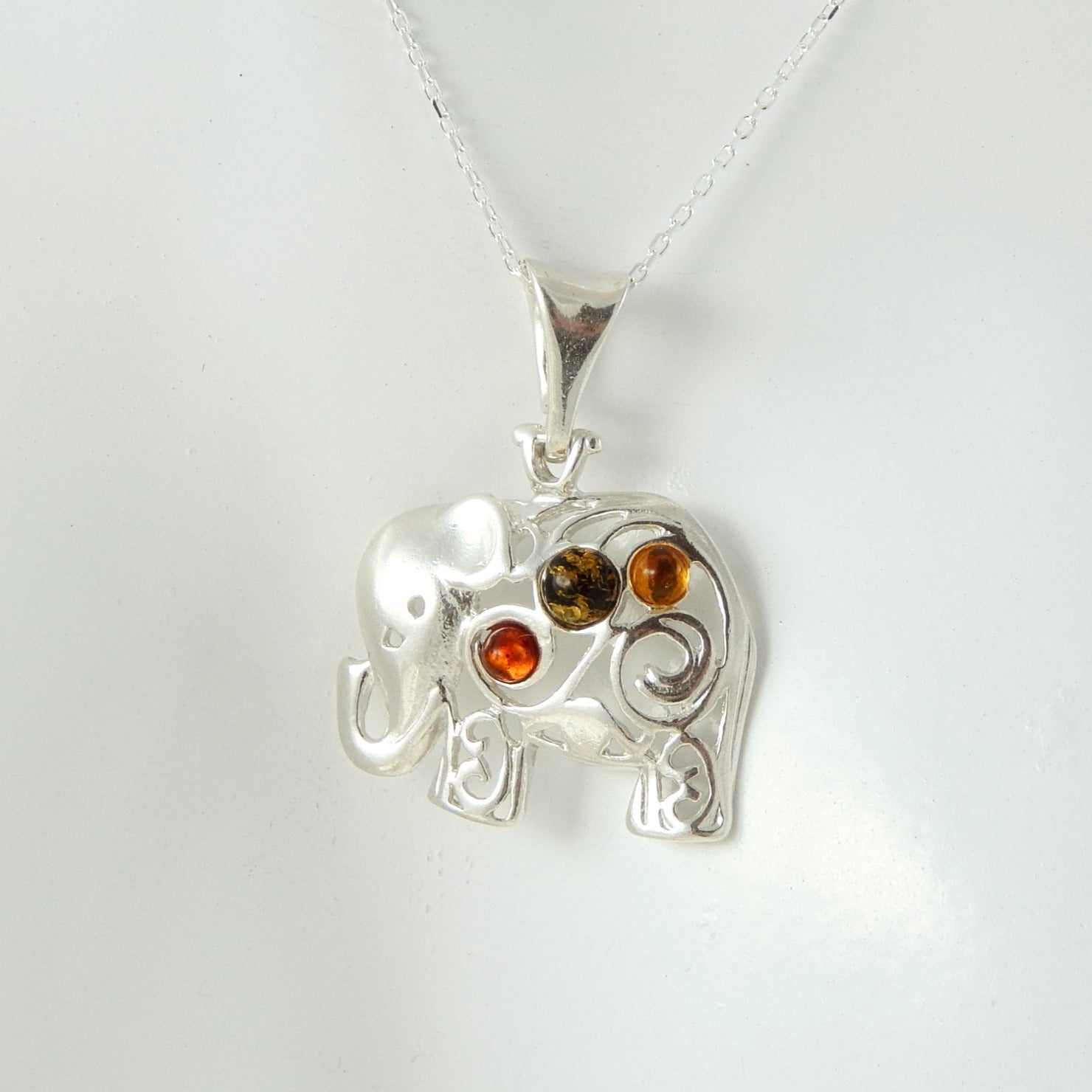 Natural Baltic multicolor amber lucky elephant pendant necklace with sterling silver chain.